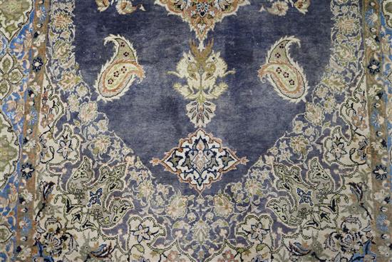 A Persian silk blue ground rug with oval medallion centre, 160cm x 165cm